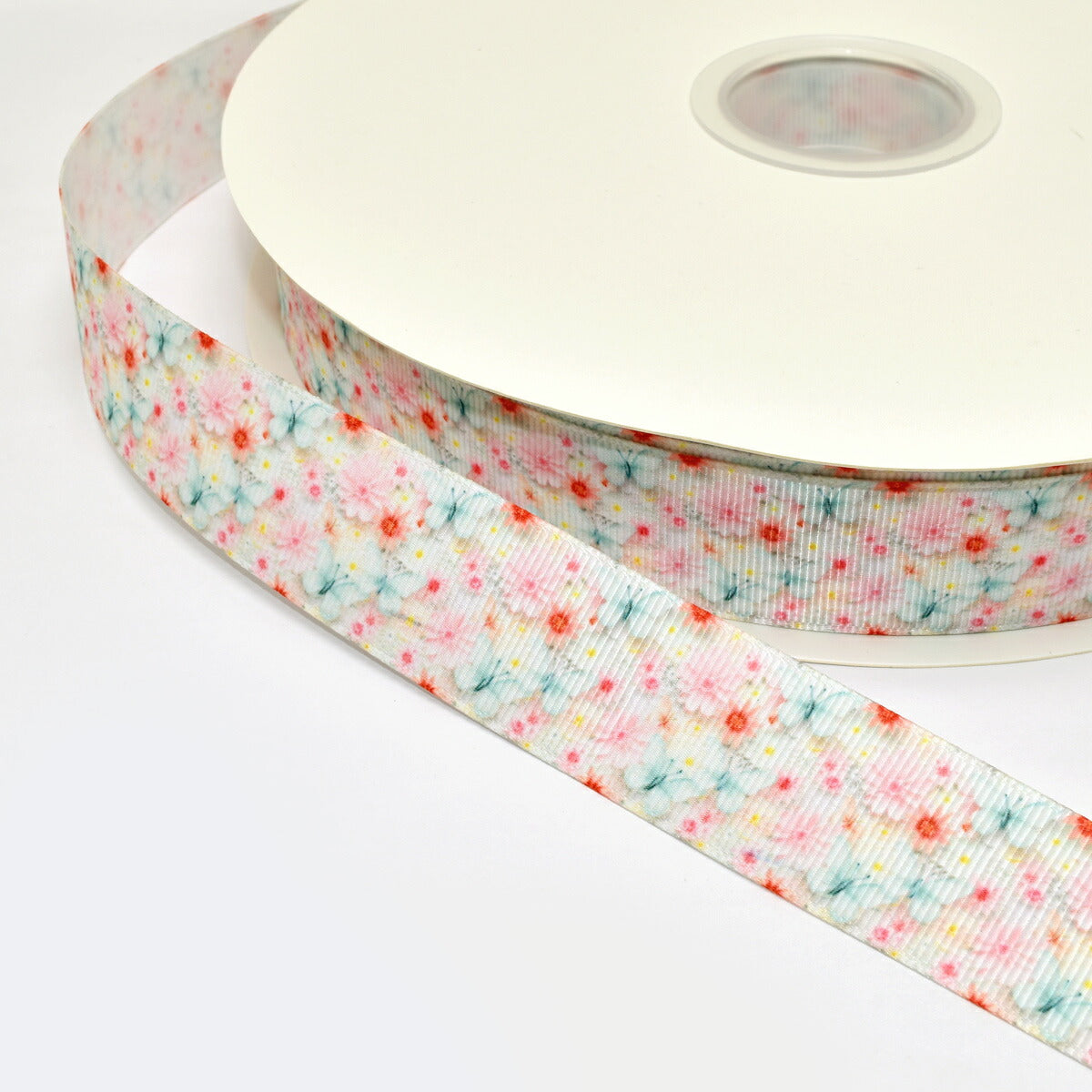 プリントリボンお花畑とブルーグリーンの蝶々リボン幅25mm1m単位切り売り(3m以上)