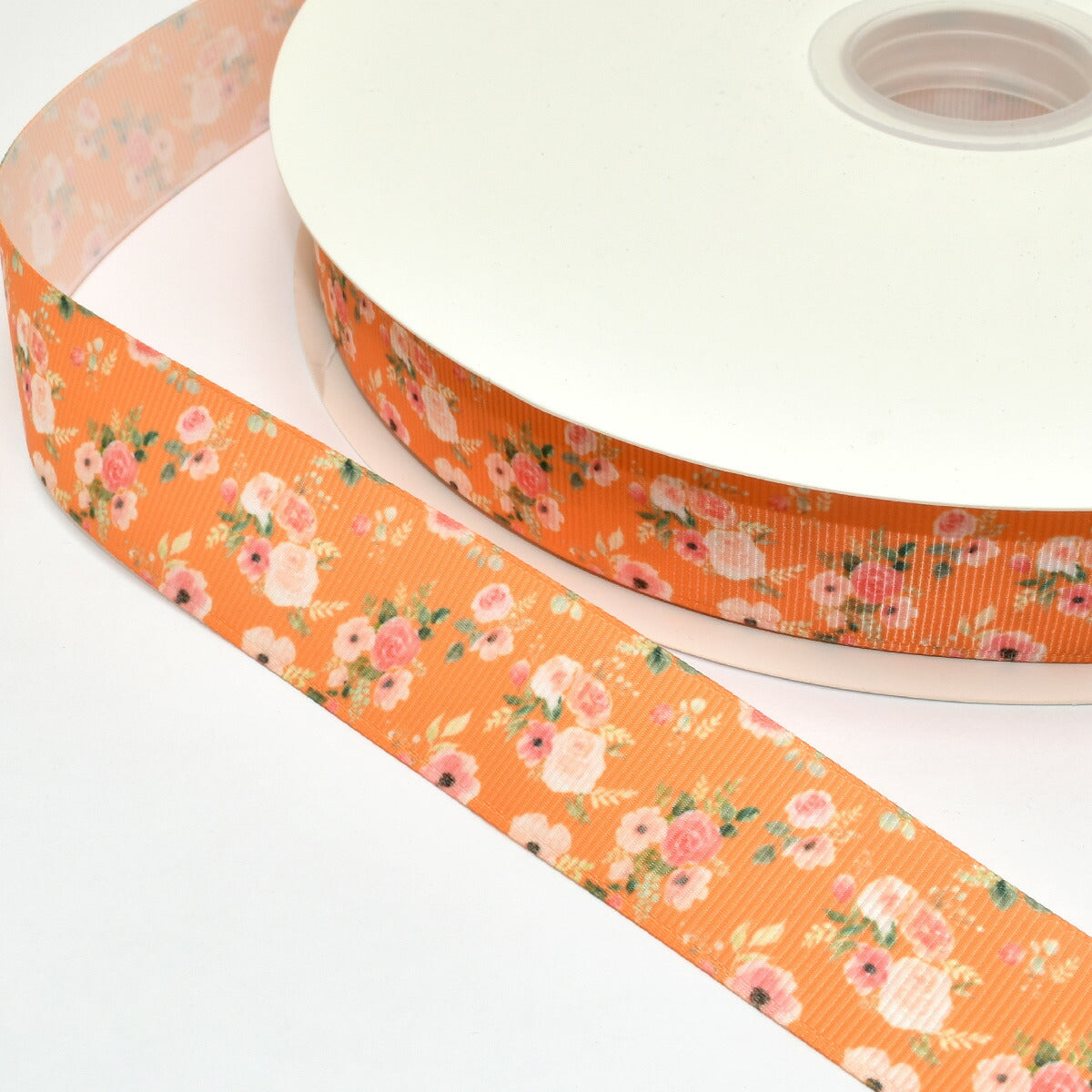 プリントリボンピンクのお花とオレンジカラーリボン幅25mm1m単位切り売り(3m以上)